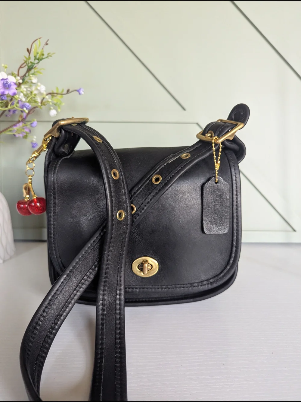Coach Black Leather Crossbody with Gold Hardware and Cherry Charm